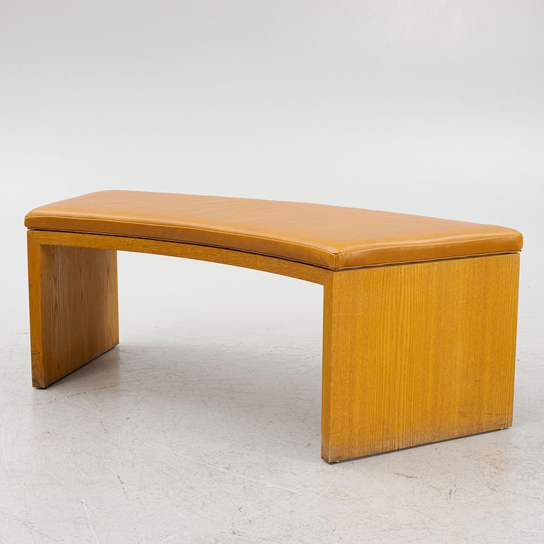 A 21st Century oak bench with leather seating.