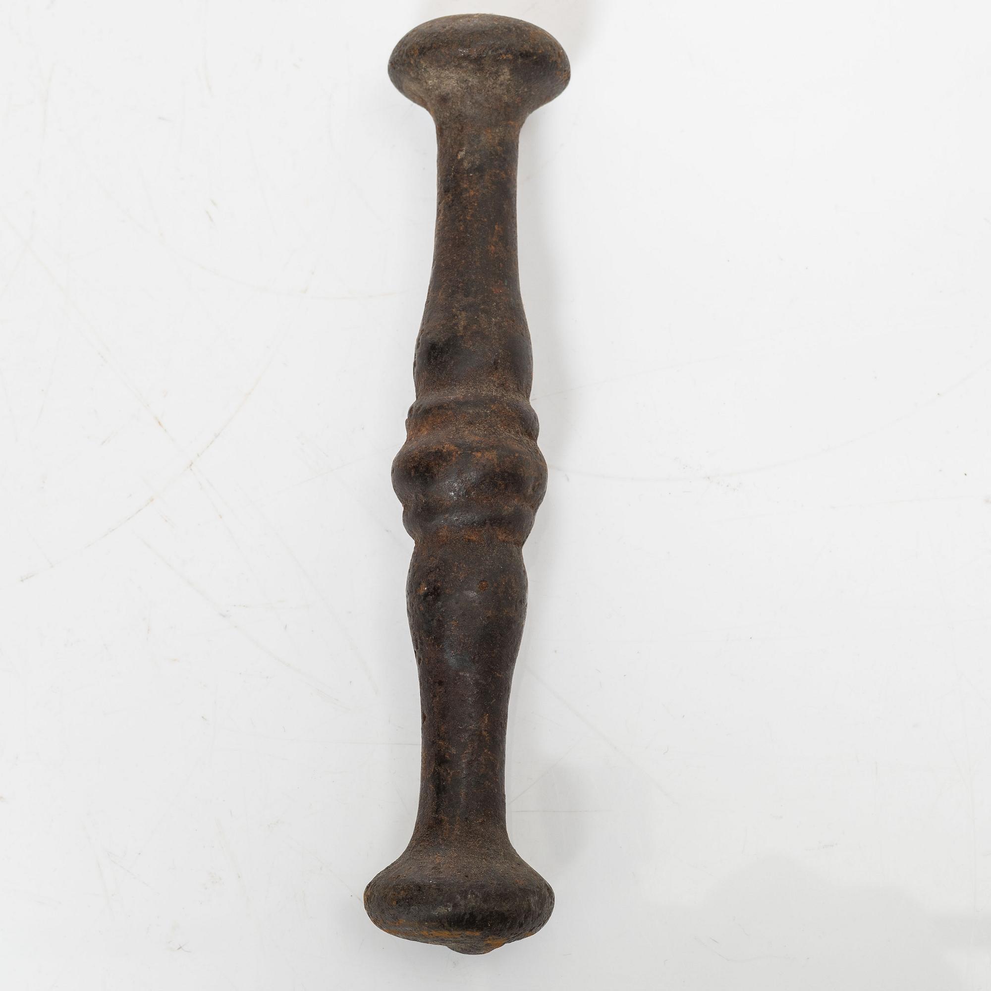 A cast-iron mortar and pestle of renaissance-type, 17th century.