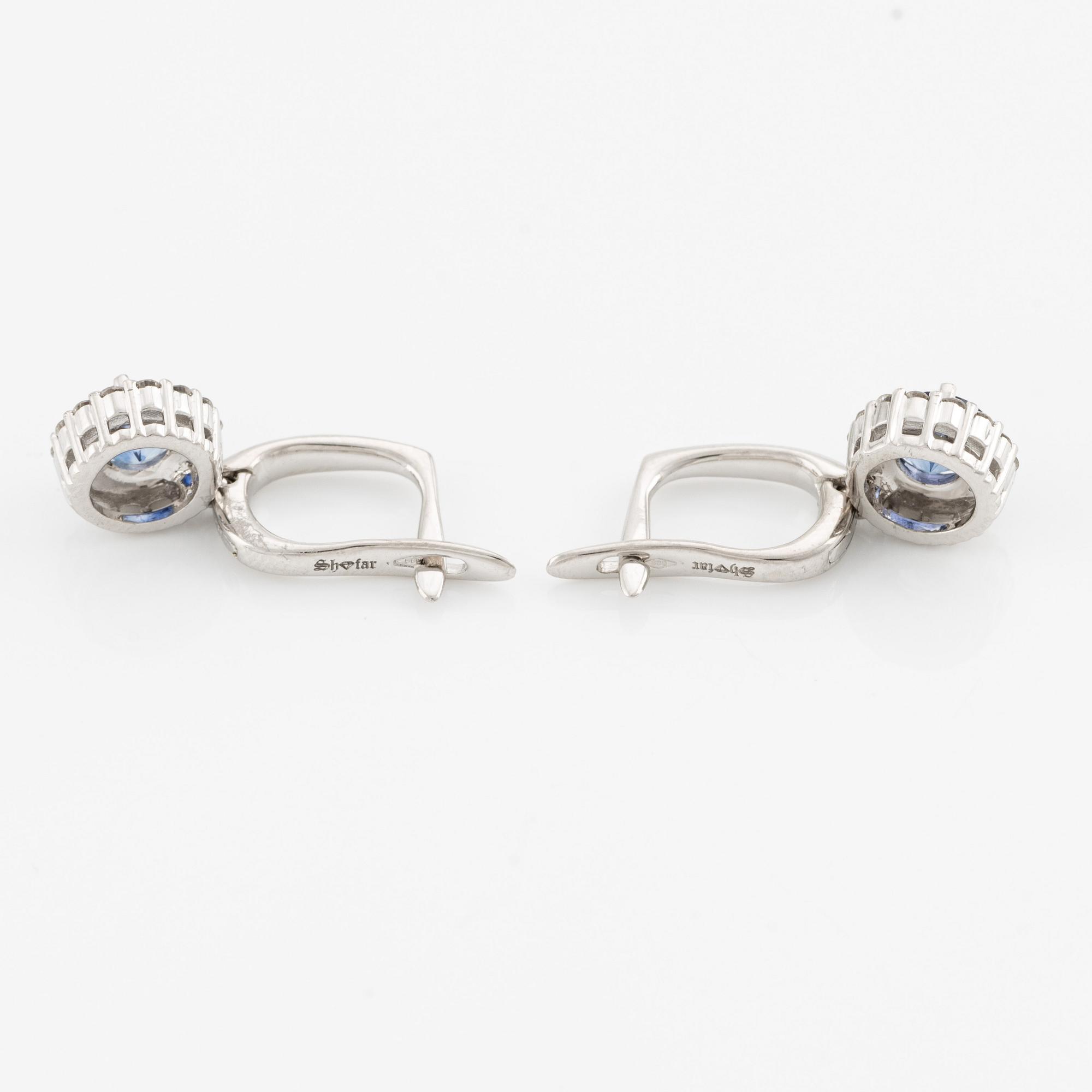 A pair of 14K gold earrings with faceted sapphires.