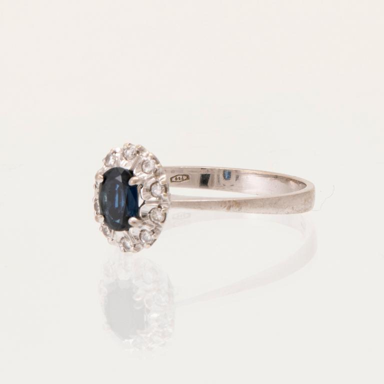 An 18K white gold carmosé ring set with an oval faceted sapphire and round brilliant-cut diamonds, Alessandria Italy.