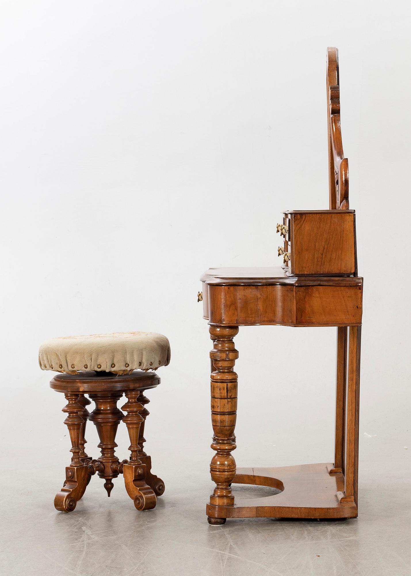 A second half of the 19th century table with mirror and a stool.