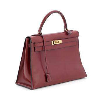 HERMÈS, a burgundy red handbag, "Kelly 32".