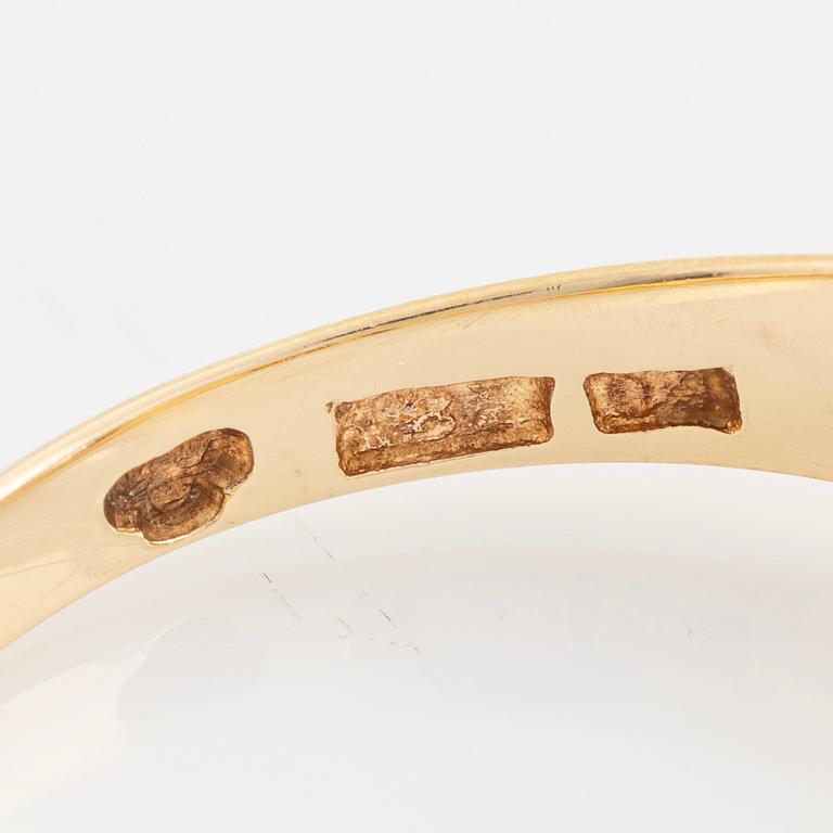 Ring, with faceted white stone.