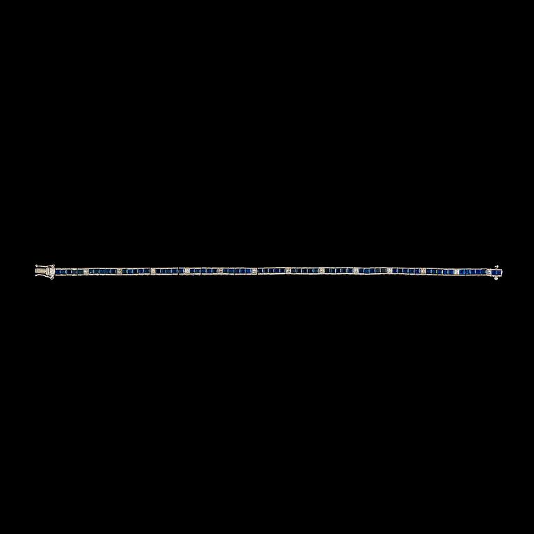 A princess-cut diamond and sapphire bracelet. Total diamond carat weight circa 0.70 ct.