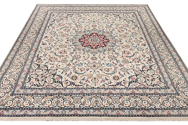 A Nain carpet, part silk, 9 laa, c. 390 x 295 cm.
