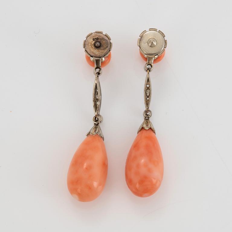 A pair of 14K white gold earrings with coral drops and old- and eight-cut diamonds.