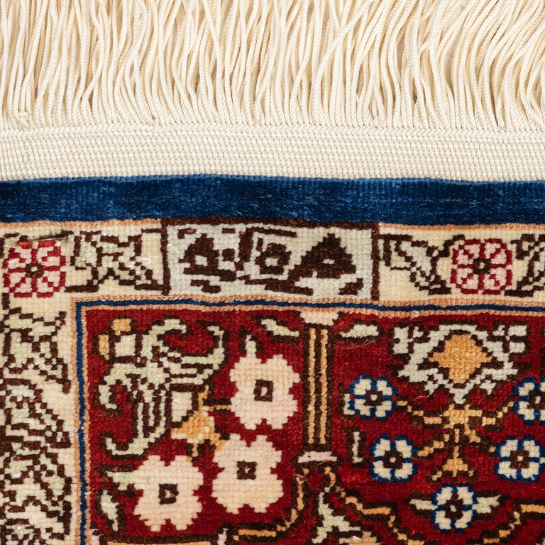 Carpets, two smaller Hereke and Ghom, silk.