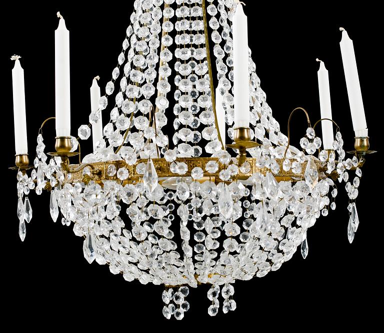 A 20th century chandelier in the Empire style. Height ca 96 cm.