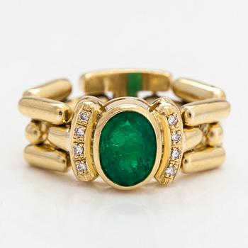 An 18K gold ring, with diamonds totalling approximately 0.08 ct and an oval-cut emerald.