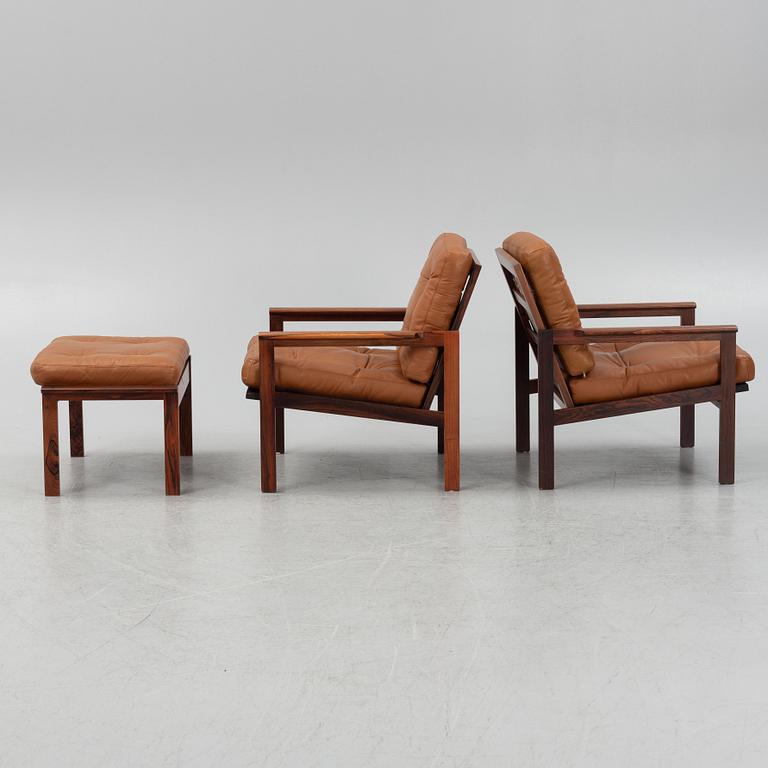 Illum Wikkelsö, a pair of 'Capella' armchairs and an ottoman, second half of the 20th century.