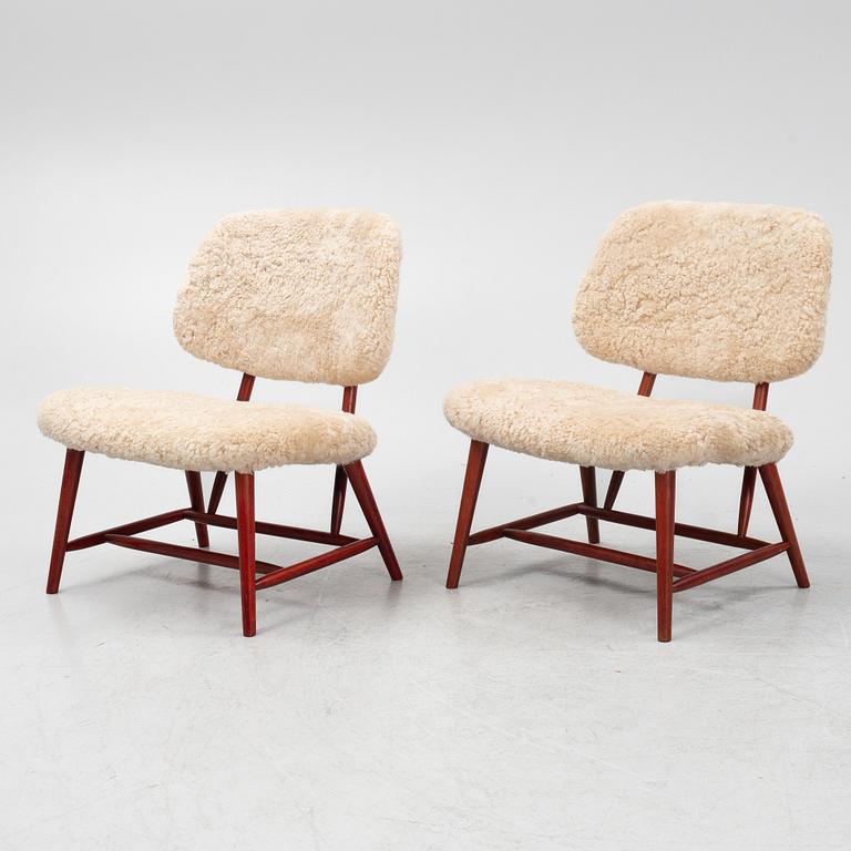 Alf Svensson, a pair of 'TeVe' easy chairs with new sheepskin upholstery, 1950s.