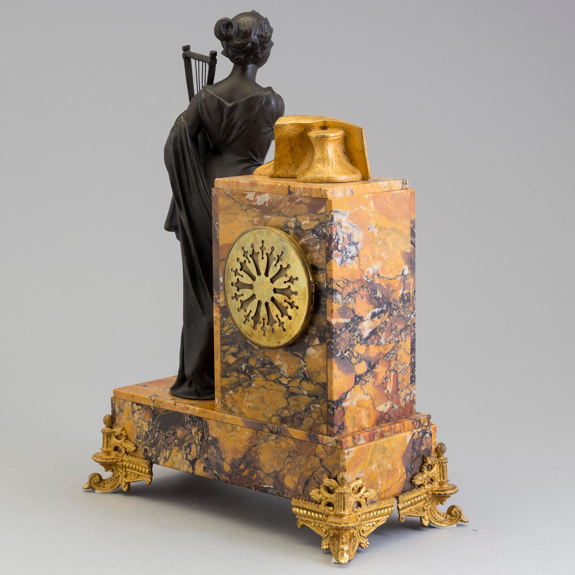 A turn of the century 1900 gilt brass and marble century mantle clock.