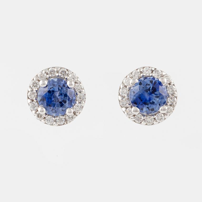 A pair of 18K gold earrings with faceted sapphires and round brilliant-cut diamonds.