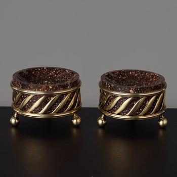 A pair of gilt silver and porphyry salts, by Gustaf Folcker, Stockholm 1827.