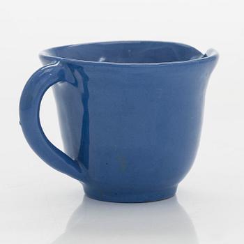 Marita Lybeck, a set of three ceramic plates and cream jug, red clay, signed ML.