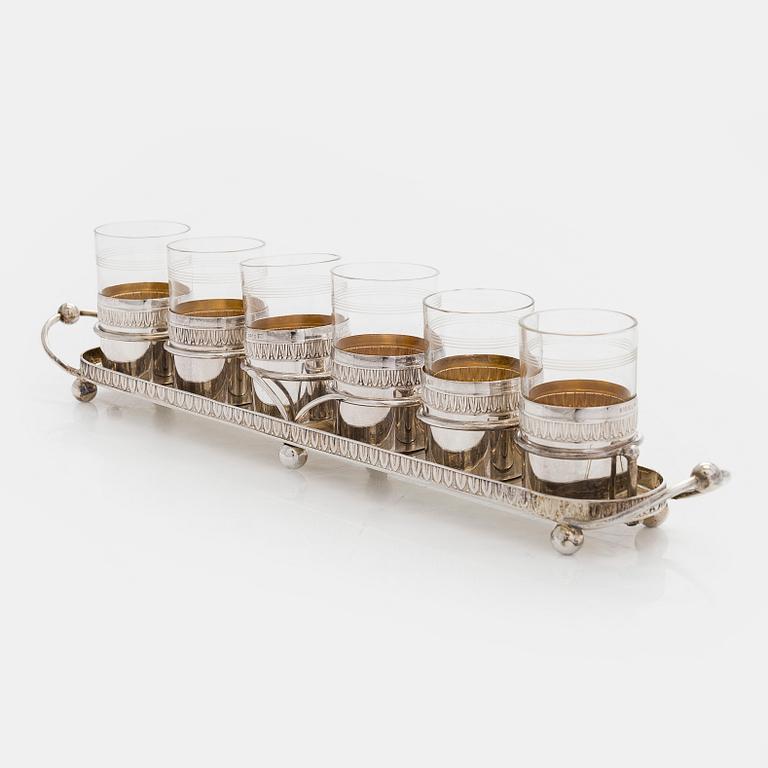 A set of six shot glasses with a tray in original fitted box, silver and glass, likely Norway 1910s.