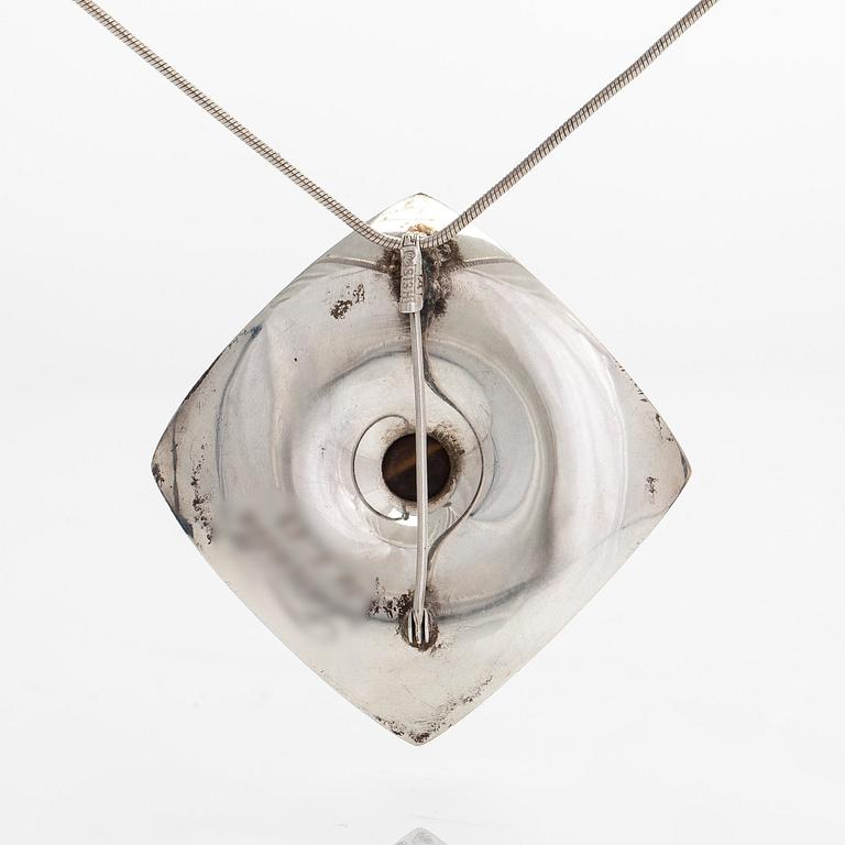 Elis Kauppi, a silver brooch/pendant, and tiger's eye. Kupittaan Kulta, Turku 1962.
