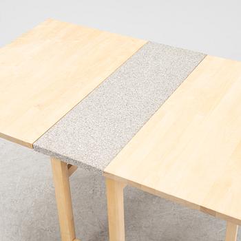 A birch gate leg table with a stone top by Marit Stigsdotter for Stolab, dated 2002.