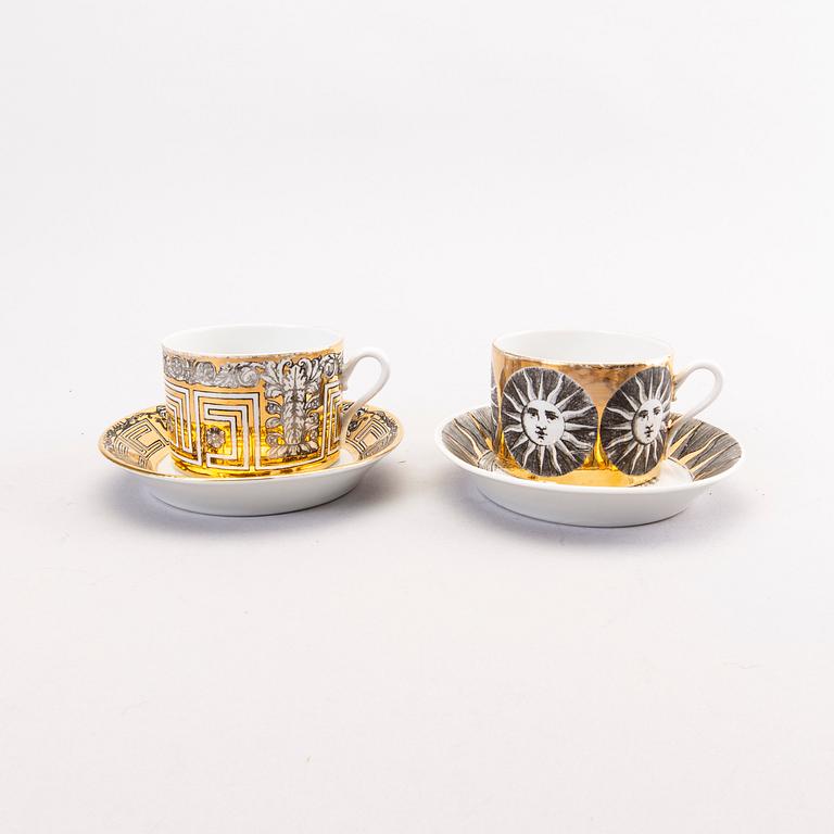 Piero Fornasetti a set of four coffee cups with saucers and two ashtrays.