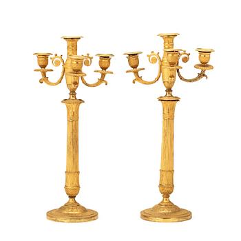 A pair of French Empire early 19th century gilt bronze four-light candelabra.