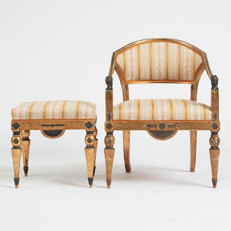 A Late gustavian armchair and stool in the manner of C G Gjörwll (1766-1837).