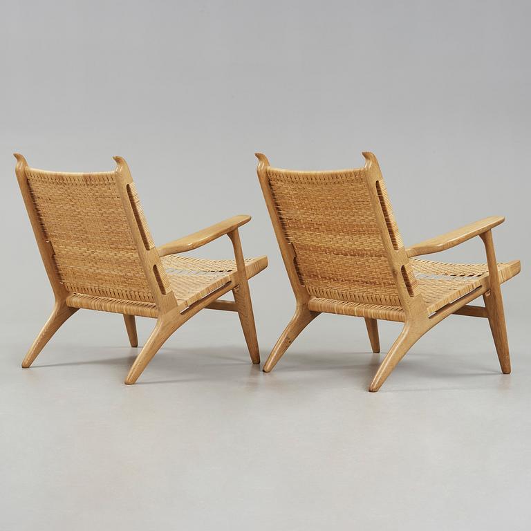 A pair of Hans J Wegner oak and rattan easy chairs 'CH-27', Carl Hansen & Son, Denmark.