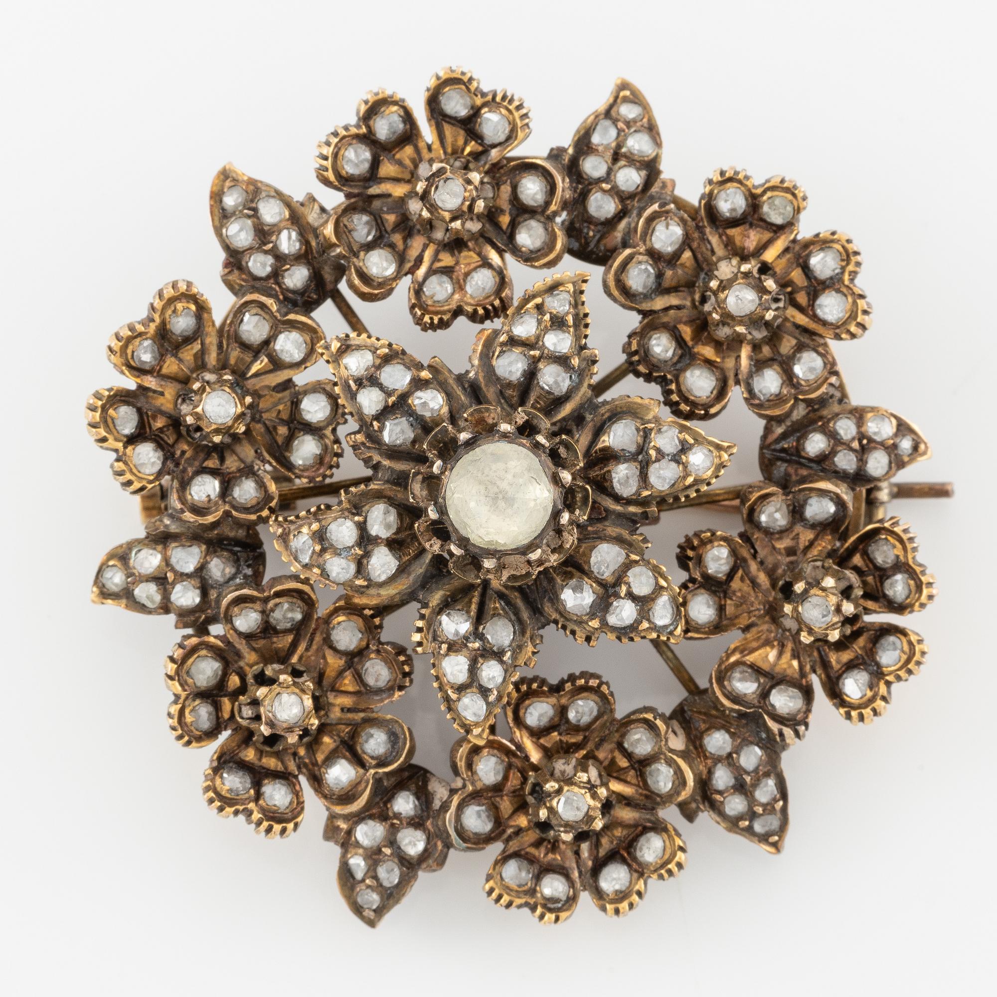 A brooch flower with rose-cut diamonds.