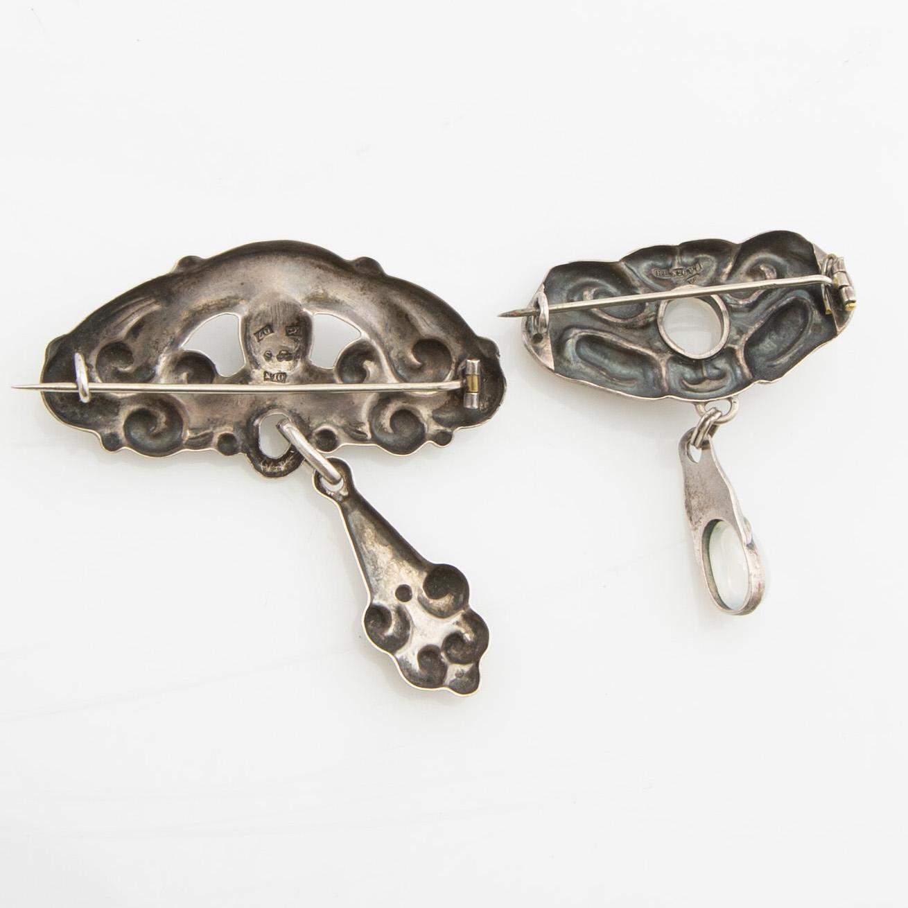 Brooches, 2 pieces, Art Nouveau, early 20th century, pewter, moonstone, and green stone.