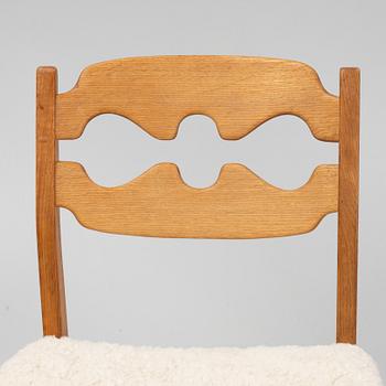 Henning Kjærnulf, a set of six oak 'razorblade' chairs, with new sheepskin upholstery, for EGK, 1960s.