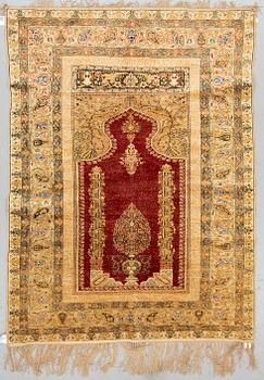 A RUG, a semi-antique Turkish, ca 182,5-185 x 136,5-139,5 cm (as well as ca 1,5 cm flat weave at the ends).