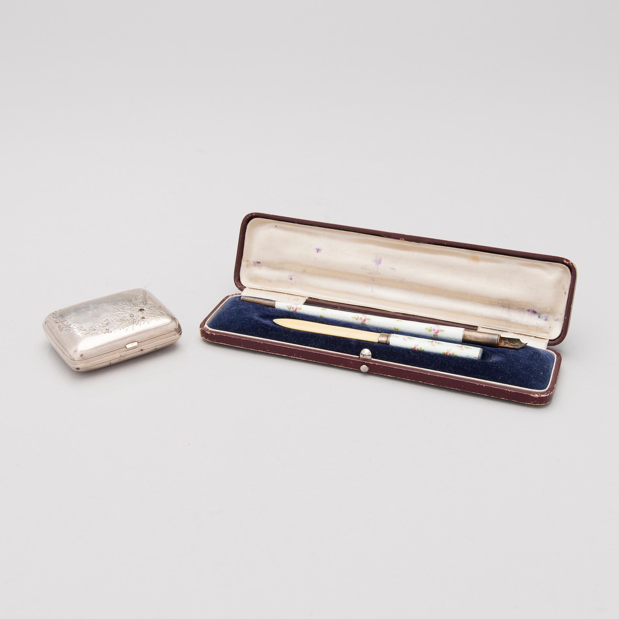A silver case, Nikolai Kemper, and a pen and a paper knife in silver and enamel, import marks St Petersburg early 1900s.