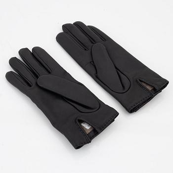 Hermès, a pair of black 'Kelly' kidskin and lambskin gloves, french size 7.