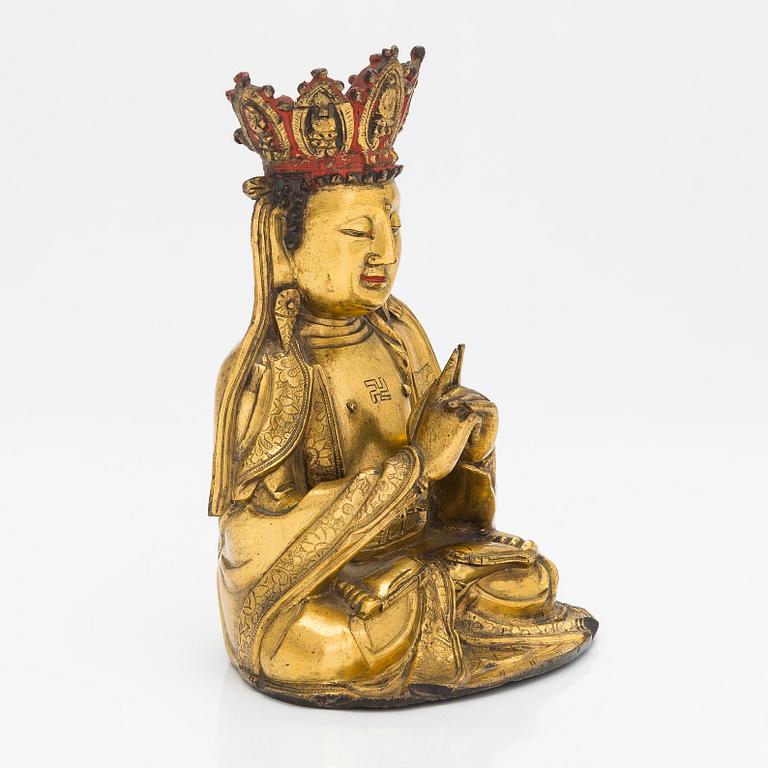 A gilt-bronze figure of Vairochana, Ming dynasty (1638-1644).