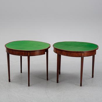 A pair of George III demi-lune mahogany card tables, first half of the 19th Century.