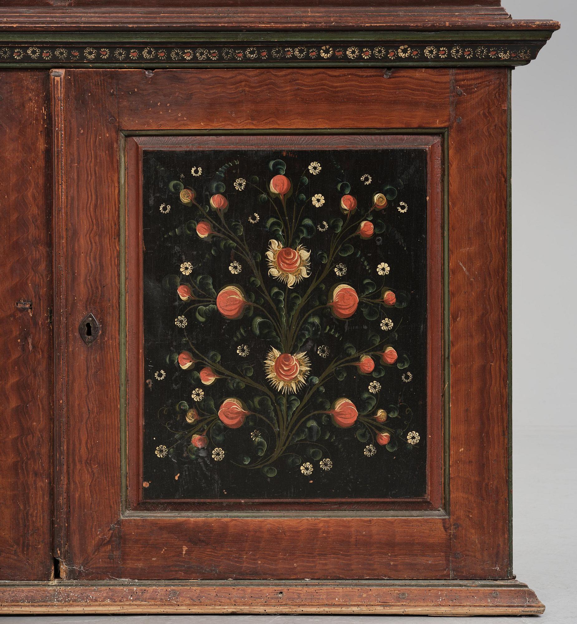 A Swedish polychrome painted folk art corner cabinet, dated 1818.