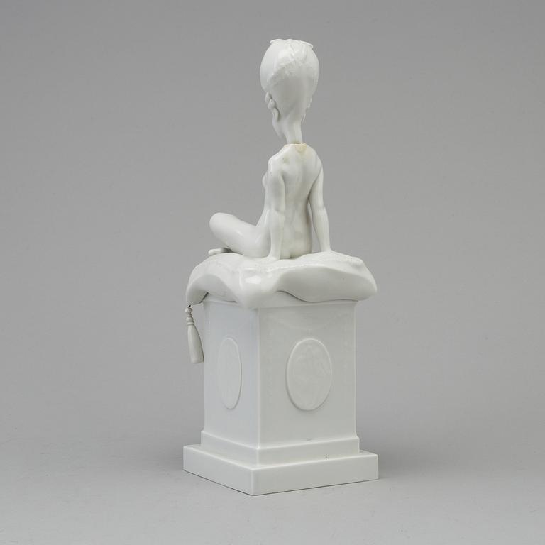 A white glazed Royal Copenhagen porcelain nodding head figure, Denmark, early 20th Century. Not first quality.