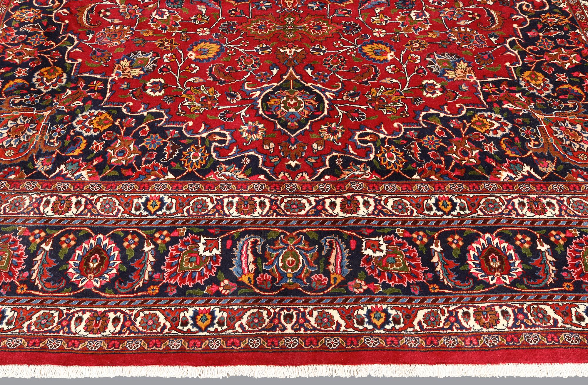 A signed Mashad carpet, ca 375 x 303 cm.