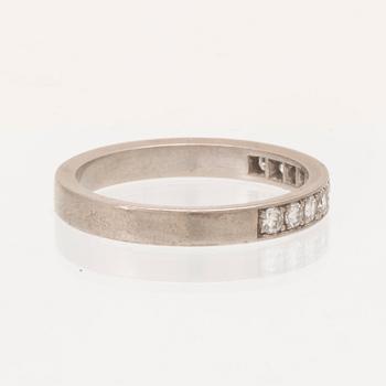 An 18K white gold half eternity ring set with round brilliant-cut diamonds.