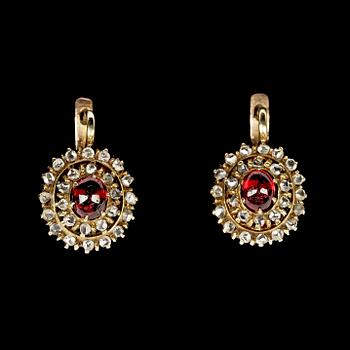 1005. EARRINGS, cabochon cut rubies and rose cut diamonds. Russian, 1900.