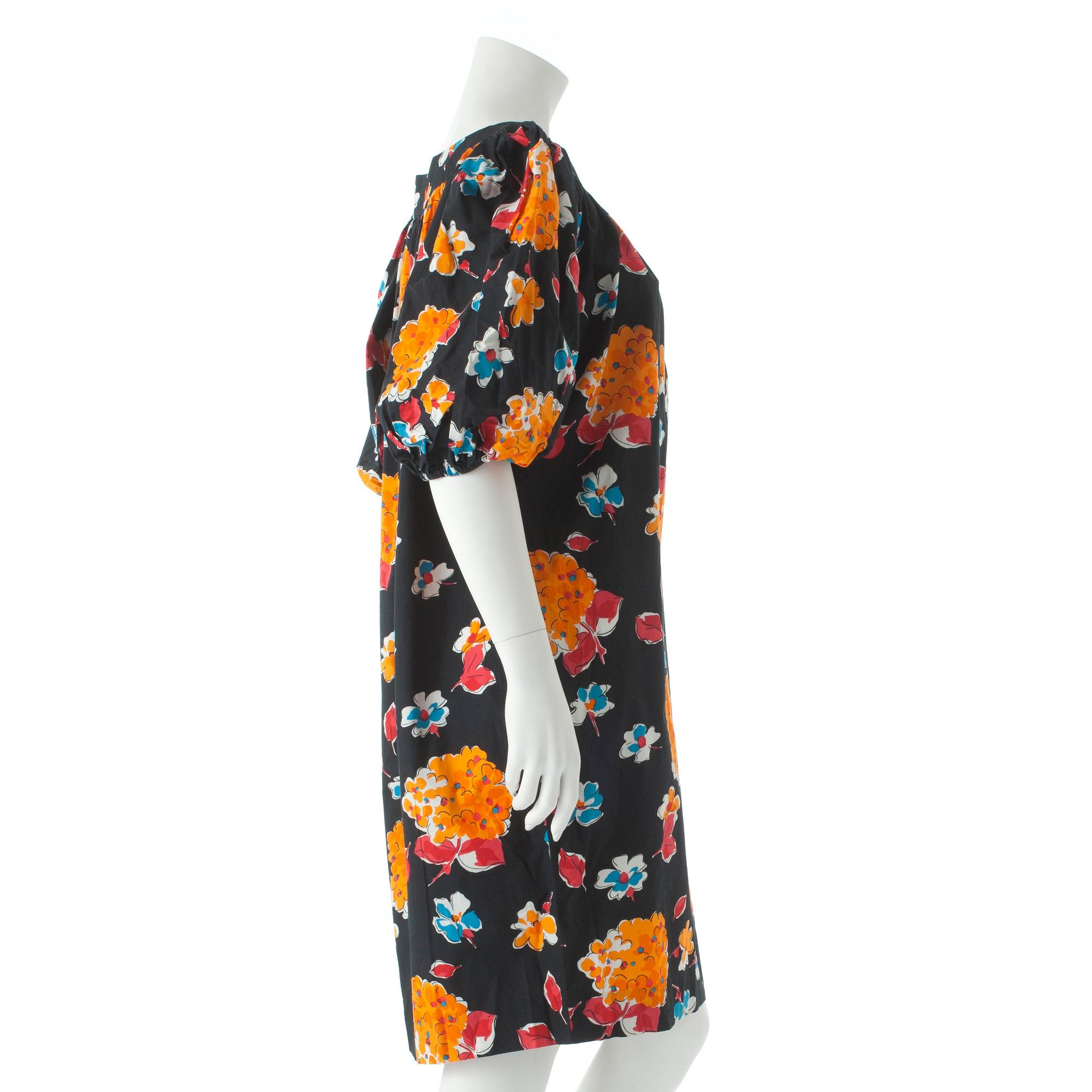 YVES SAINT LAURENT, a black cotton dress with flower motif.