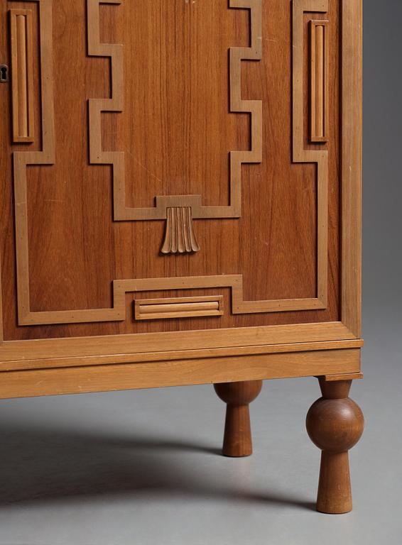 A Swedish Grace mahogany showcase cabinet, reportedly a win at the Stockholm Cabinetmaker's association lottery, 1920's.