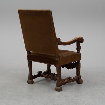 A carved baroque style armchair from around 1900.