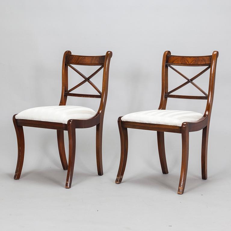 A dinner table and thirteen chairs, England, latter half of the 20th-century. Chairs marked Rosjohn,