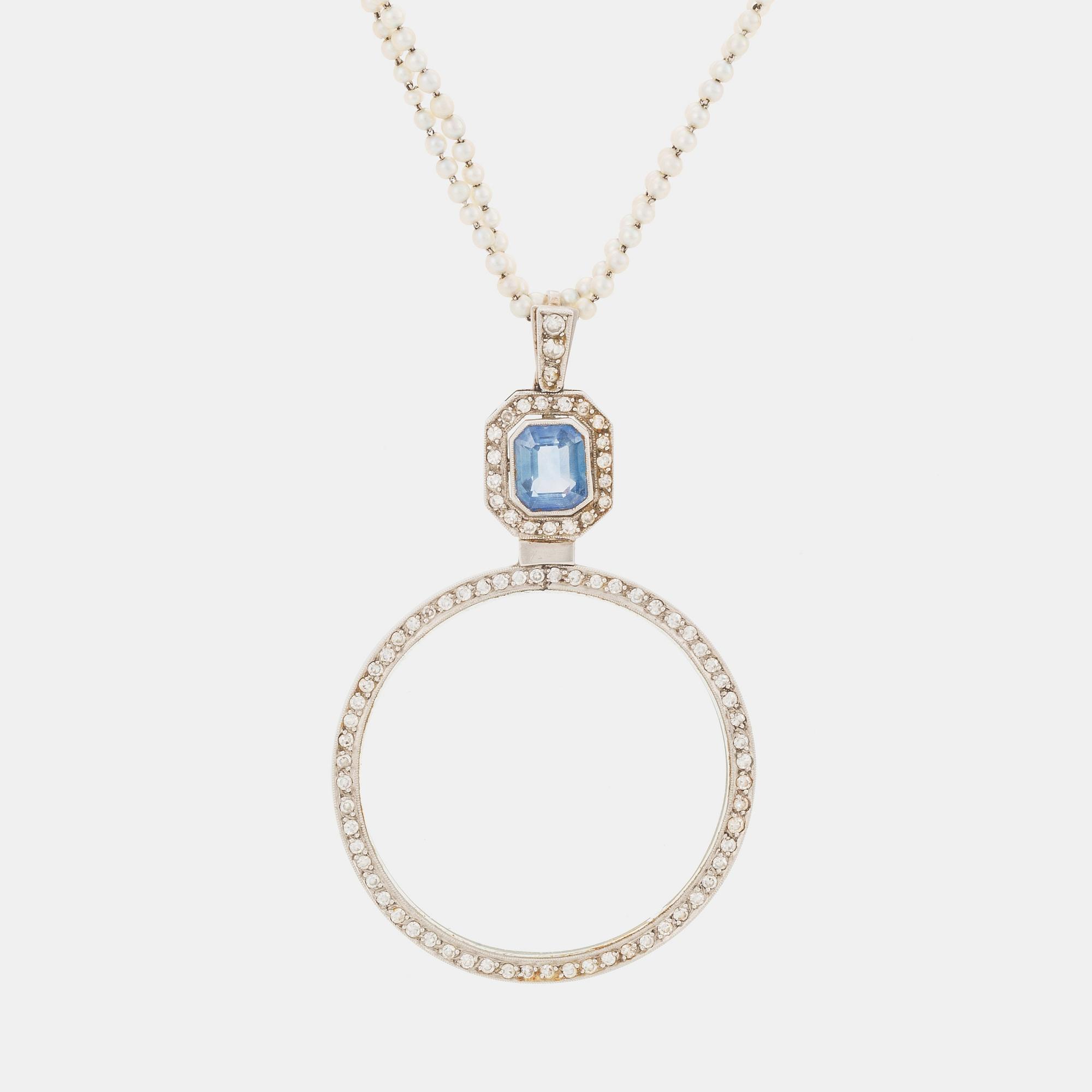 A platinum lorgnette set with a faceted sapphire and rose-cut diamonds.