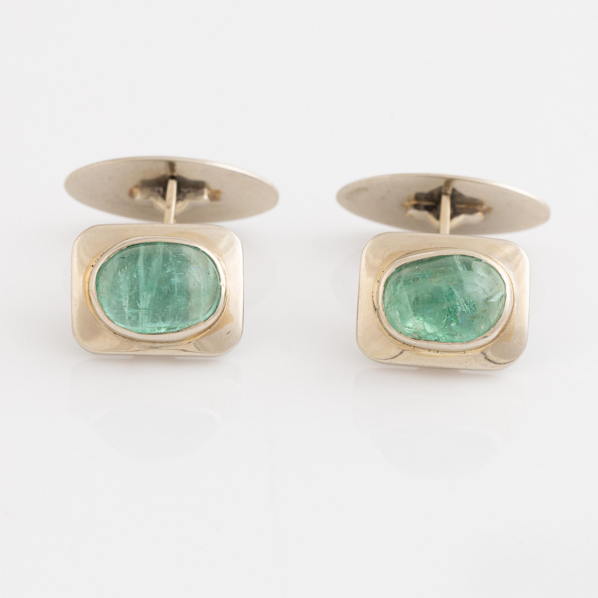 18K white gold and cabochon cut emerald cufflinks.