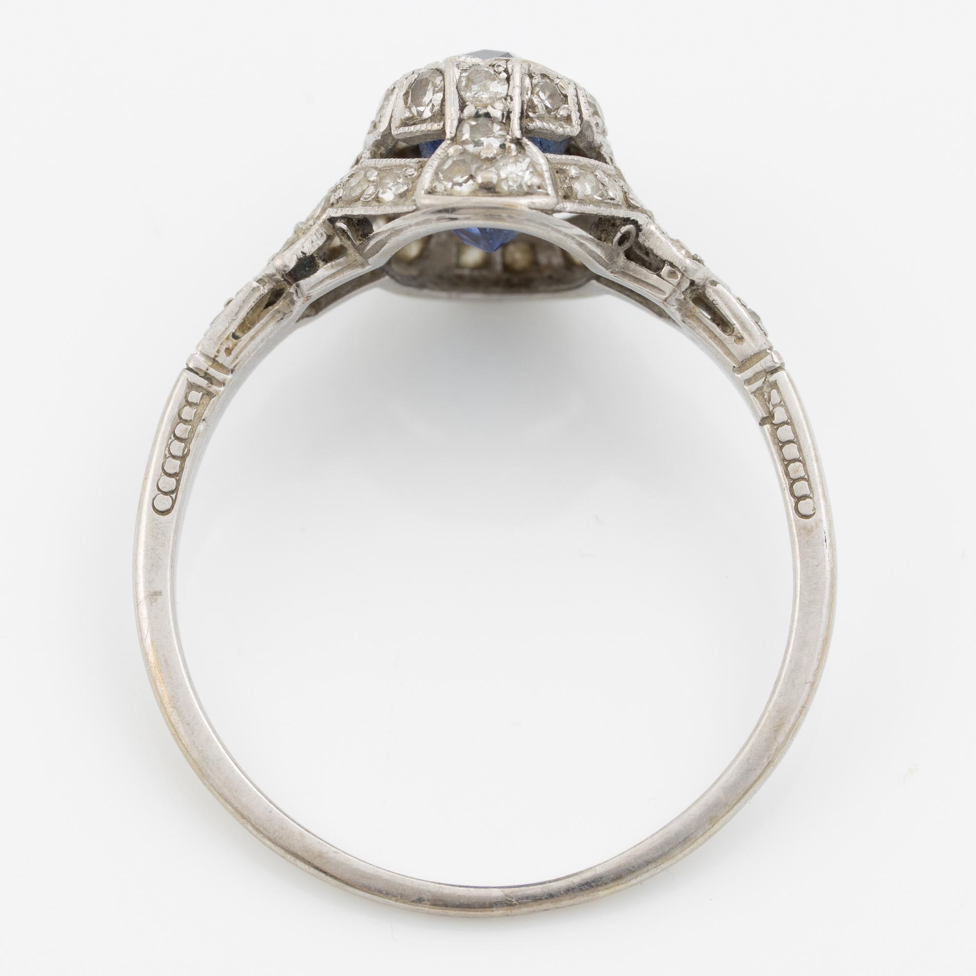 Ring 14K gold with a synthetic blue stone and small diamonds and white stones.