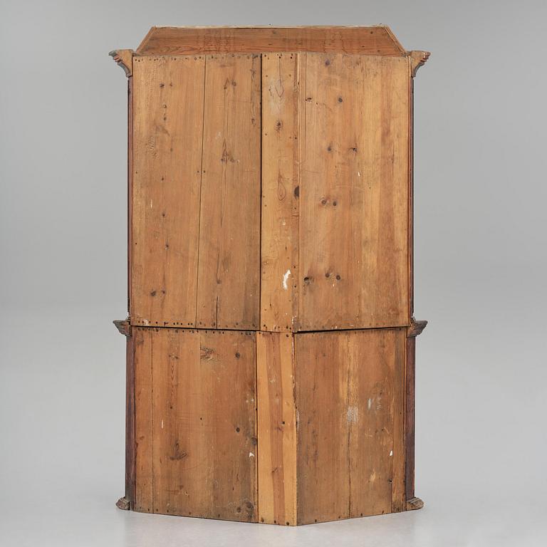 A Swedish polychrome painted folk art corner cabinet, dated 1818.