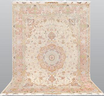 A signed Tabriz carpet, partly silk, so called 60 Raj, c 358 x 246 cm.