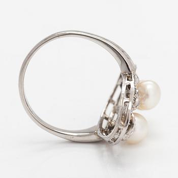A platinum ring with old- and rose-cut diamonds and cultured pearls.