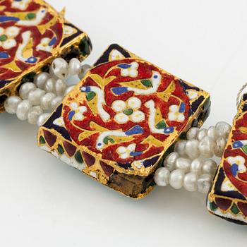 An antique gold and enamel Qajar necklace with pearls set with turquoises and with a garnet drop.